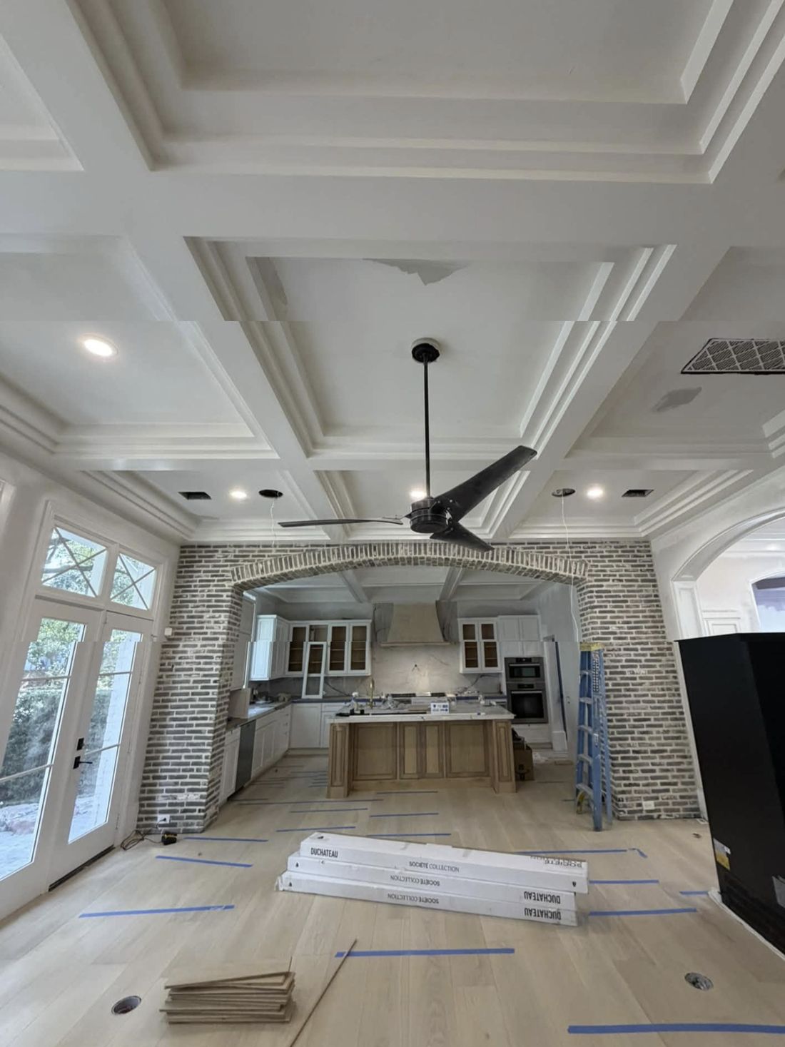 Coffered ceiling and brick wall in a kitchen, in progress